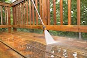 Pressure washing wood deck.